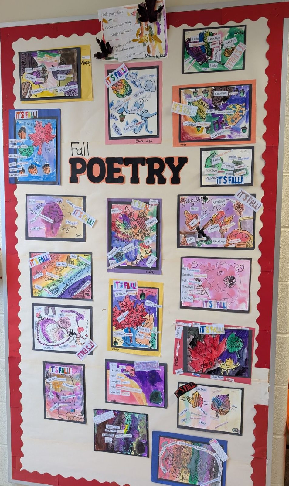A tall bulletin board of autumn watercolour paintings with cut-out words like Hello and Goodbye